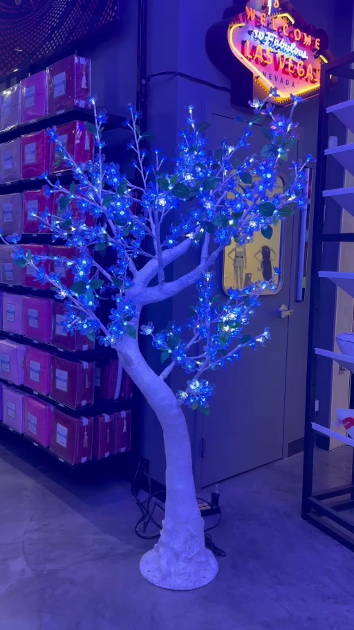 Blue illuminated decorative tree displayed inside the HolySheets Galleria showroom