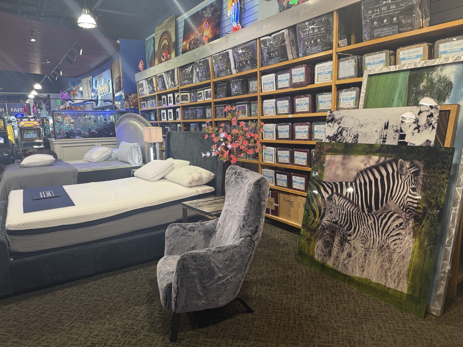 Mattress display with framed wall art inside HolySheets Galleria