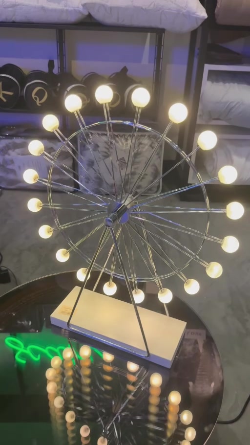 Ferris wheel-shaped decorative table light displayed among pillows in the HolySheets Galleria showroom