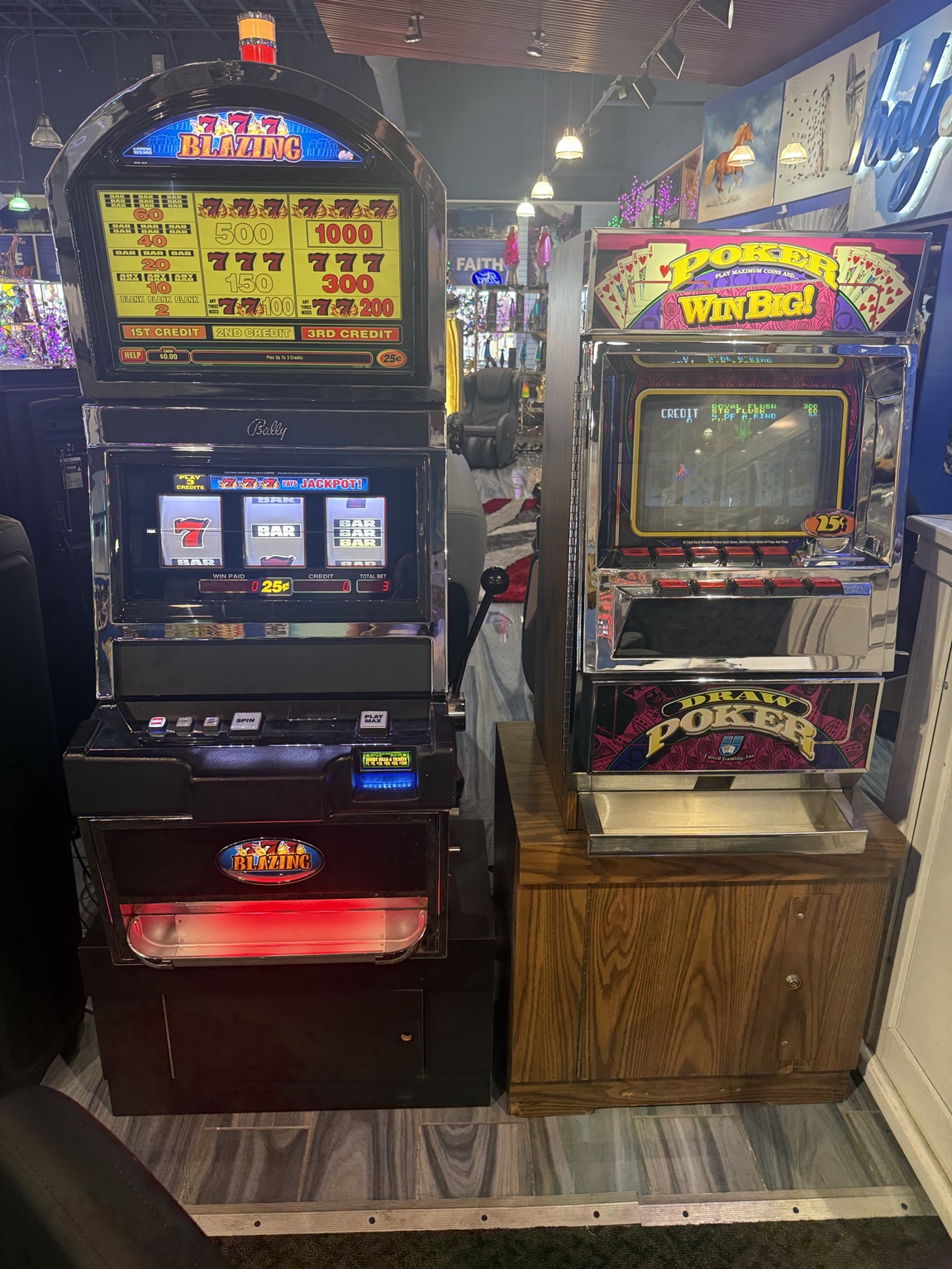 Two illuminated vintage-style arcade game machines displayed inside HolySheets Galleria